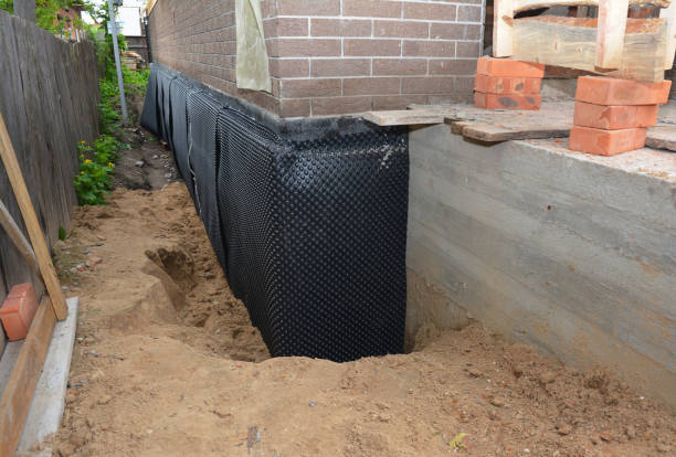 Happy homeowners after waterproofing job in Laurel